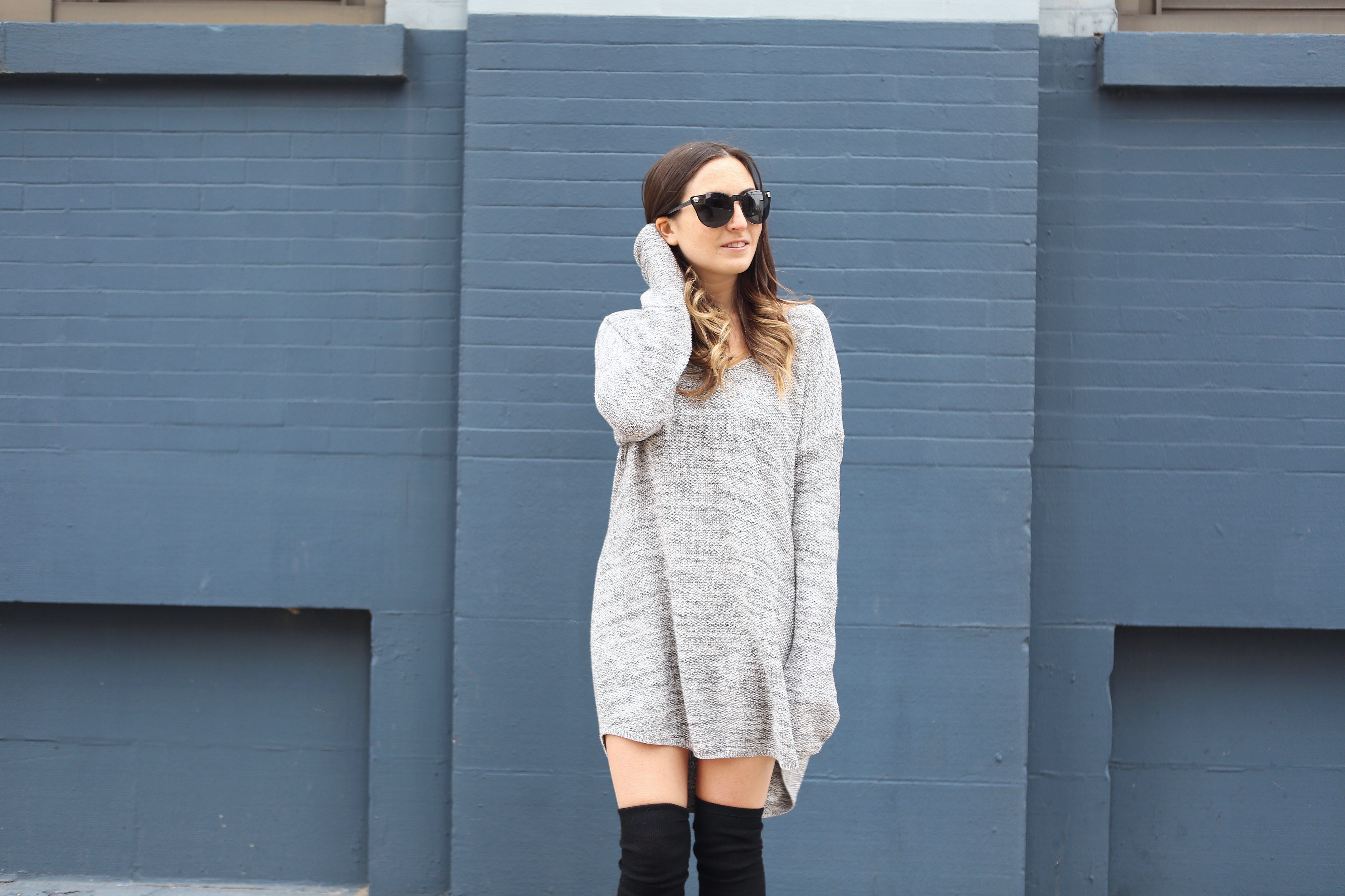 sweater dress with thigh high socks.
